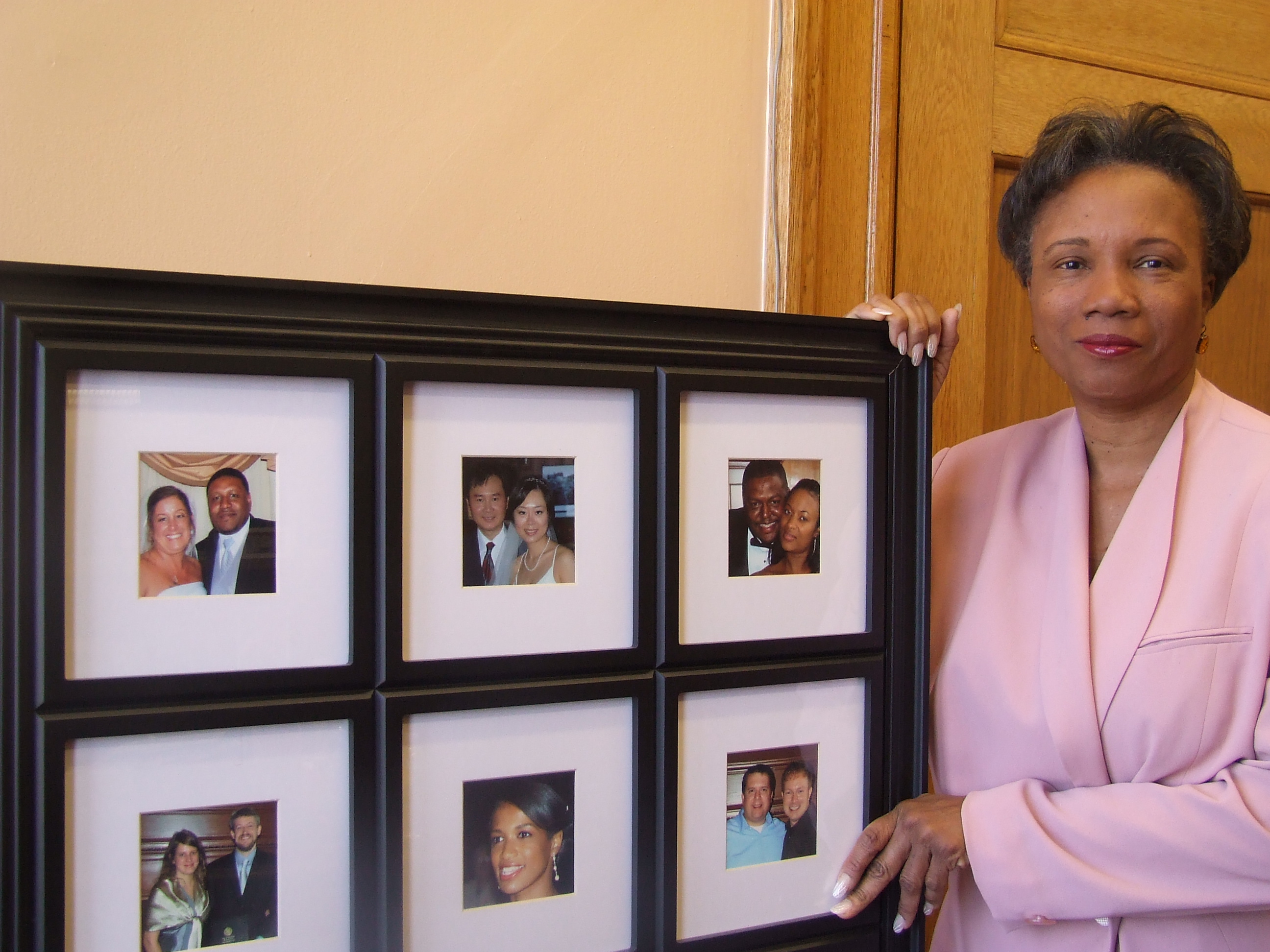 Cambridge Mayor E Denise Simmons, who is also a justice of the peace, shows pictures of both gay and straight couples she has married.  Photo by Talia Whyte